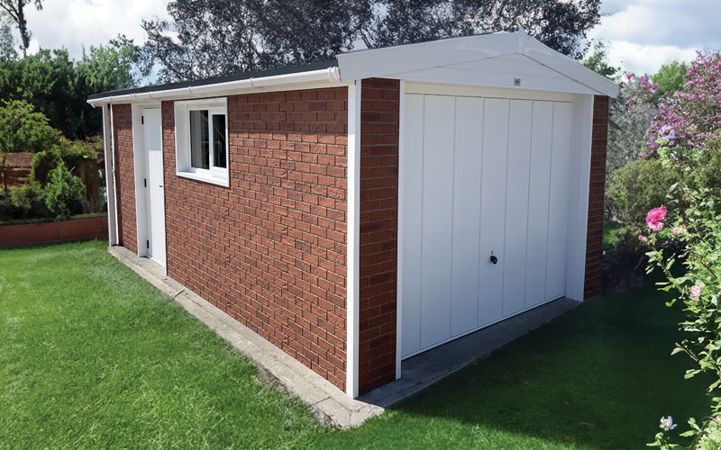 Brick garden shed with white double doors, white trim, and a side door against a grassy backyard with a window on the side wall.