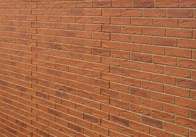 BRIXK-CLADS - All Seasons Steel Buildings Close-up of a red brick wall with horizontal mortar joints.