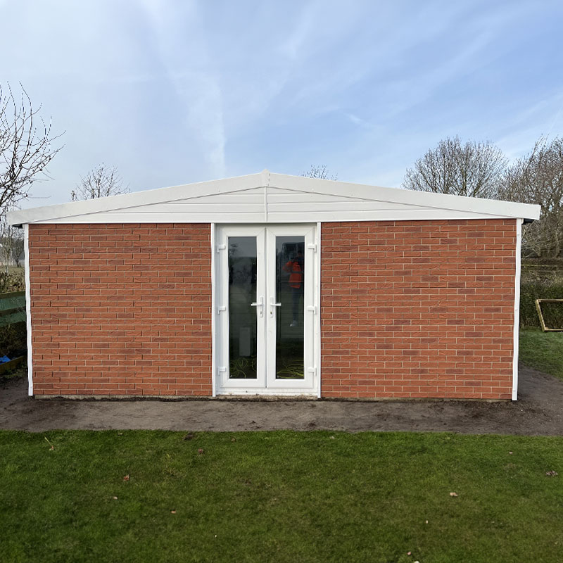 GARDEN-BRICK-1 - All Seasons Steel Buildings Brick garden shed with white-framed glass double doors and a white pitched roof