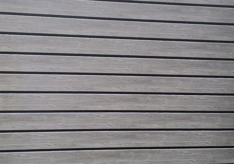 PLANK-CLAD - All Seasons Steel Buildings Wooden deck or plank flooring with evenly spaced dark gaps between light brown boards.