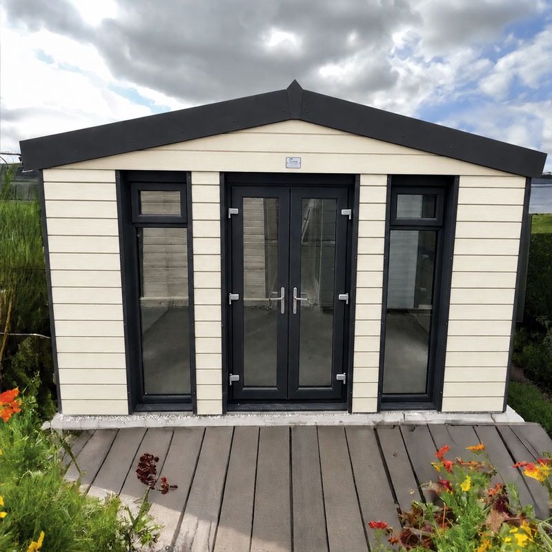 Small beige garden shed with black-framed glass doors and side windows on a wooden deck, under a cloudy sky