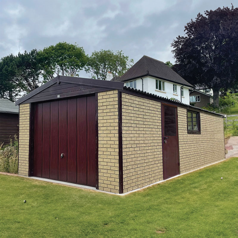 Brick outbuilding with a large dark wooden double garage door, a side door, and a window, on a green lawn with a house and trees in the background.