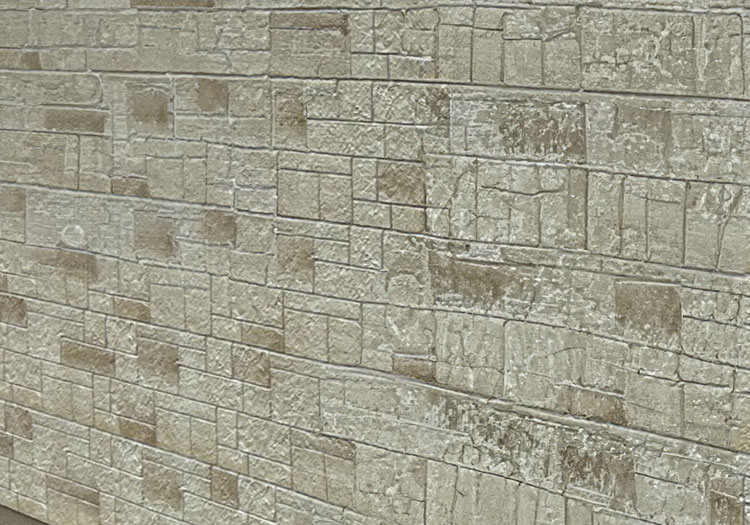 STONE-CLADS - All Seasons Steel Buildings Beige stone brick wall with rectangular blocks and weathered texture.