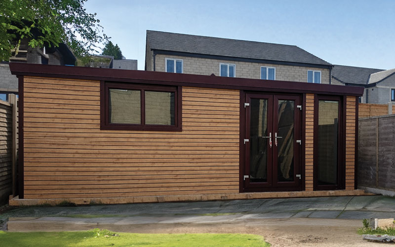 Wooden garden shed in a suburban backyard with a dark-framed double door and a window on the side panel.