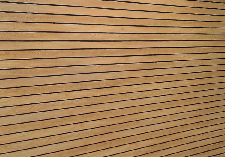 WOOD-CLAD - All Seasons Steel Buildings Close-up of light wooden planks with evenly spaced dark grooves running horizontally across the surface.